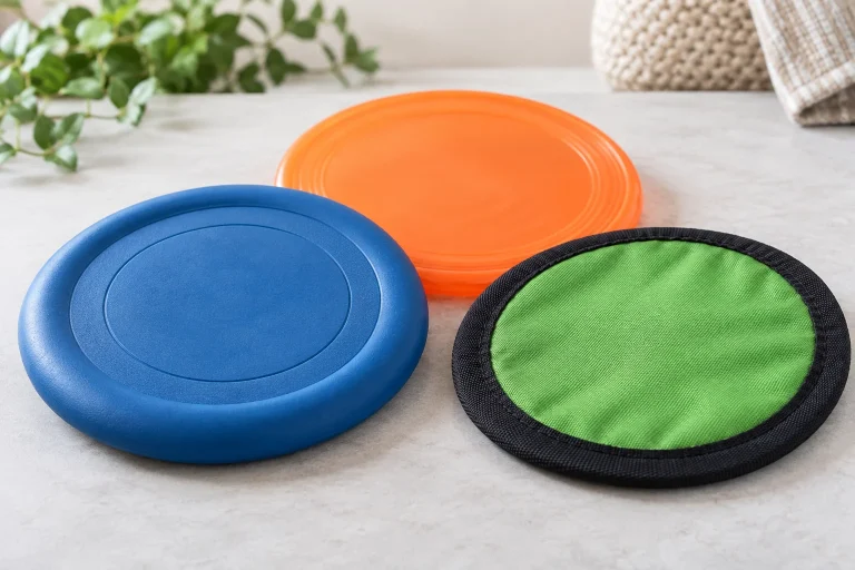 Dog frisbee constructions showing molded rubber flexible plastic and fabric rims
